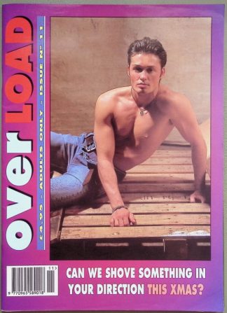 Overload magazine cover: shirtless man posing on wooden planks, purple border, bold Xmas headline.